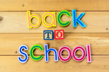 Back to school. Close up arrangement of "Back to School" alphabet on wooden background. Preschool, education, back to school and copy-space concept or other your content.
