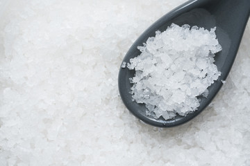 Crystal sea salt for food ingredient in a spoon, close up