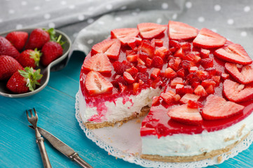 Strawberry summer fresh red fruit and delicious dessert cake on blue wooden background