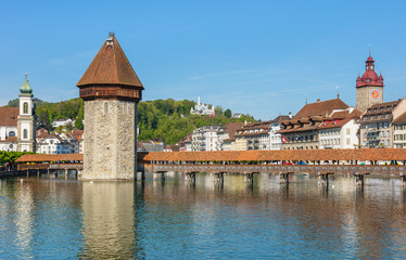 Springtime view in the city of Lucerne, Switzerland: the Reuss river, Water Tower, Chapel Bridge
