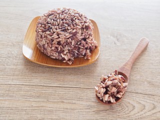 Thai Steam Rice Berry in a wooden dish and spoon on an old wooden table in a healthy diet. And the benefits of nutrition. Strengthens the body and shape.