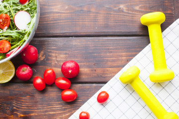 Diet food ingredients on dark wooden background