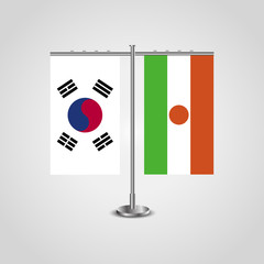 Table stand with flags of South Korea and Niger.Two flag. Flag pole. Symbolizing the cooperation between the two countries. Table flags