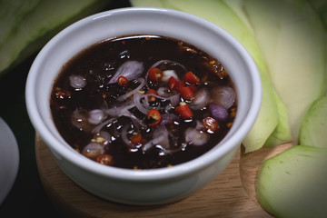 sliced green mango with sweet fish sauce decorate with ingredients on banana leaf background, Thai food on summer