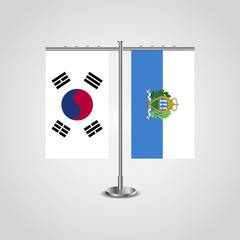 Table stand with flags of South Korea and San marino.Two flag. Flag pole. Symbolizing the cooperation between the two countries. Table flags