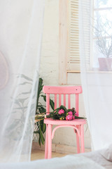 Pink chair with pink rose