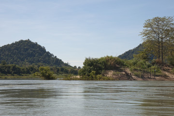 Stung Treng Cambodia, island in middle of Mekong river, mountain and riverbank in background