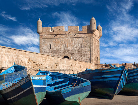 Old blue boats and ancient Fortress in harbour of Essaouira on the Atlantic coast in Morocco, Africa