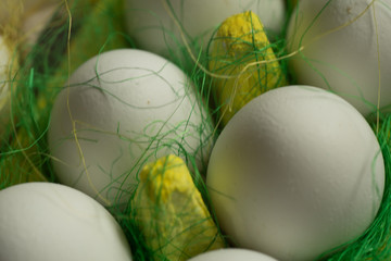 Chicken eggs in colored paper eco-friendly packaging with decorative sisal. Close-up photo, macro. Easter background Food concept 