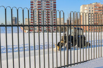 Cleaning the tractor of an open ice rink at the stadium
