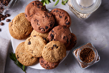 Roasted coffee beans get out of overturned glass jar on homespun tablecloth, selective focus, side view