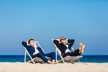 Woman and man relaxing on beach