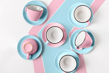 Elegant porcelain blue and pink cups on abstract background