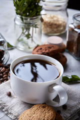 Breakfast background with mug of fresh coffee, homemade oatmeal cookies, grind coffee