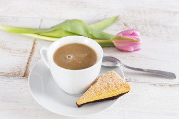 cup of coffee and tulip and cake