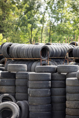 A large stack of used automotive car tires