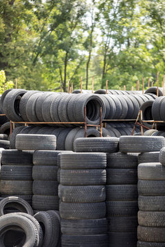A large stack of used automotive car tires