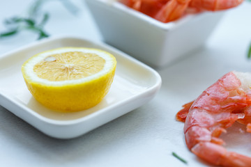 row tiger shrimp with lemon on white