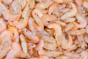A pile of frozen shrimps in supermarket as background, texture