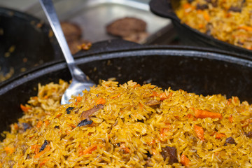 Cooking a pilaf on a frying pan. Shallow depth of field