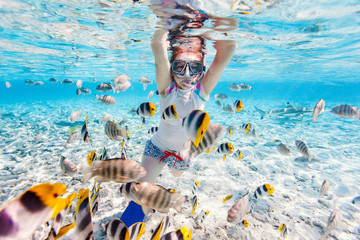 Woman snorkeling with tropical fish