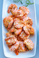 row tiger shrimp with lemon on white