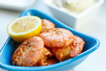 row tiger shrimp with lemon on white