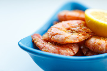 row tiger shrimp with lemon on white