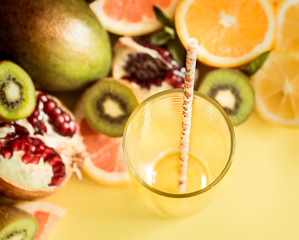 various fruits and a glass with a straw