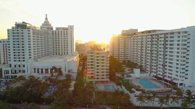 Aerial sunset behind apartment buildings Miami Beach FL