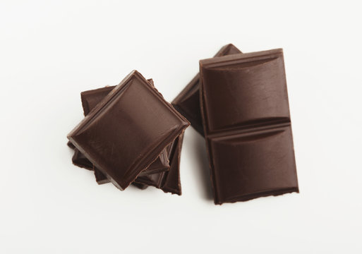 Bar of dark chocolate isolated on white