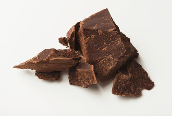 Heap of chocolate pieces isolated on white