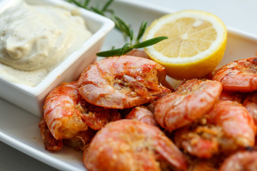 row tiger shrimp with lemon on white