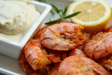 row tiger shrimp with lemon on white