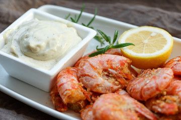 row tiger shrimp with lemon on brown