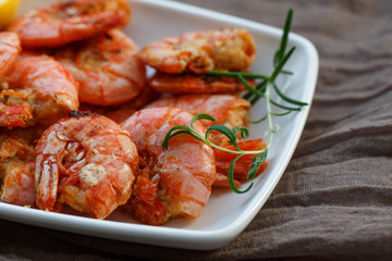 row tiger shrimp with lemon on brown