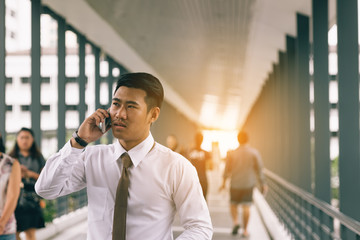 Businessman talking on the phone with stressed about the job.