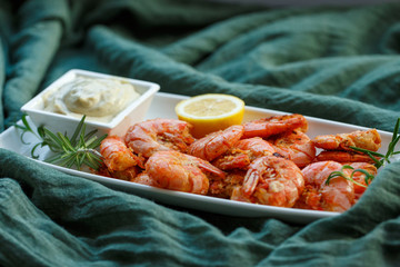 row tiger shrimp with lemon on green