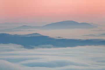 Fototapeta na wymiar Summer mountain landscape with the sea fog