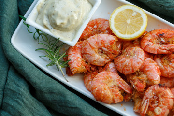 row tiger shrimp with lemon on green