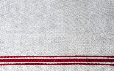Simple homespun linen towel with red stripes. Background, texture, copy space