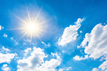 Sunny background, blue sky with white clouds and sun © Günter Albers