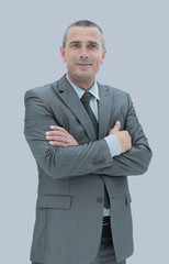 Portrait of successful  mature business man smiling against gray