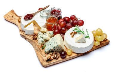 various types of cheese and jam on wooden cutting board