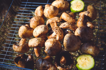 Mushrooms of brown champignon poribello are cooked on the grill or barbecue, and small drops of water. Preparation of mushrooms on the grill of Portiballo pickled. Fried vegetables on a grill closeup.