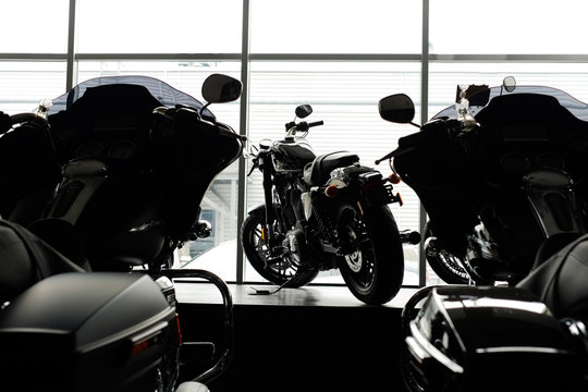image of a new motorcycle in the store. Motorcycles and accessories in a modern motorcycle store. cool motorcycle in the motor cabin silhouette. The concept of motorcycles