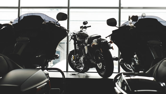 image of a new motorcycle in the store. Motorcycles and accessories in a modern motorcycle store. cool motorcycle in the motor cabin silhouette. The concept of motorcycles