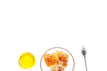 Honeycomb filled with honey on plate on white background top view space for text