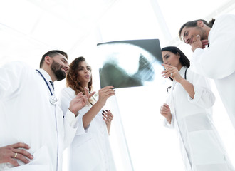 Fototapeta na wymiar medical workers looking at patient's x-ray film