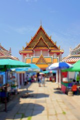 The entrance to the Thai temple, shops and tourists.